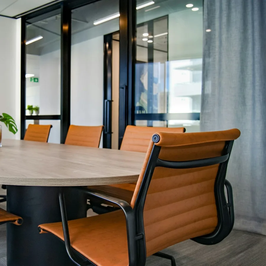 Clean office meeting room with orange chairs
