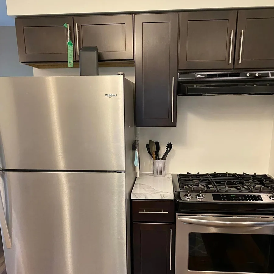 Clean kitchen with stainless steel fridge and stove